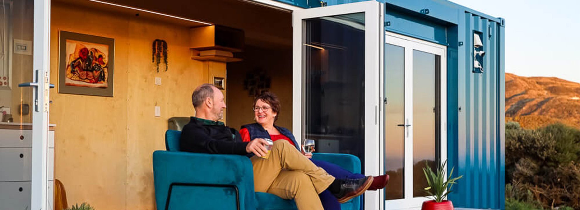 couple relaxing on the deck of their container home